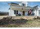 Inviting front porch with swing and seating, perfect for relaxing and enjoying the outdoors at 3344 Cobb Farm Trl, Mebane, NC 27302