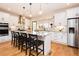 Modern kitchen features white cabinets, granite countertops, stainless steel appliances, and an island with barstool seating at 3344 Cobb Farm Trl, Mebane, NC 27302