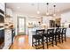 Bright kitchen features white cabinets, granite countertops, stainless steel appliances, and an island with barstool seating at 3344 Cobb Farm Trl, Mebane, NC 27302