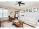 Bright living room with hardwood floors, white sofa, fireplace, and neutral decor at 3344 Cobb Farm Trl, Mebane, NC 27302