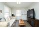Inviting living room area with a comfortable sofa, television, and neutral color scheme at 3344 Cobb Farm Trl, Mebane, NC 27302