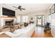 Comfortable living room with a fireplace, hardwood floors, and plenty of natural light at 3344 Cobb Farm Trl, Mebane, NC 27302