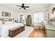 Bright main bedroom featuring hardwood floors, a ceiling fan, a chest of drawers and light-filled windows at 3344 Cobb Farm Trl, Mebane, NC 27302