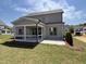 Covered back porch featuring a concrete floor, screened-in walls, and a view of the backyard at 3521 Amelia Grace Dr # 67, Fuquay Varina, NC 27526