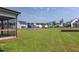 Large, well-maintained backyard with a view of neighboring houses and a screened porch at 3521 Amelia Grace Dr # 67, Fuquay Varina, NC 27526