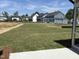 View of the backyard with a large grassy lawn and neighboring houses at 3521 Amelia Grace Dr # 67, Fuquay Varina, NC 27526
