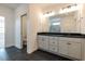 Bathroom featuring dual sinks, black floors, granite countertop, and a water closet at 3521 Amelia Grace Dr # 67, Fuquay Varina, NC 27526
