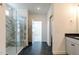 Bright bathroom featuring a glass shower with marble, dark tile floors, and recessed lighting at 3521 Amelia Grace Dr # 67, Fuquay Varina, NC 27526