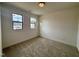 Bright bedroom with neutral carpet, white walls, and natural light from two windows at 3521 Amelia Grace Dr # 67, Fuquay Varina, NC 27526