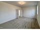 Spacious bedroom with neutral carpet and paint, featuring multiple windows and doors at 3521 Amelia Grace Dr # 67, Fuquay Varina, NC 27526