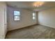 Inviting bedroom featuring two large windows, soft carpeting, and neutral paint at 3521 Amelia Grace Dr # 67, Fuquay Varina, NC 27526