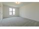 Spacious bedroom featuring soft carpeting and a large window at 3521 Amelia Grace Dr # 67, Fuquay Varina, NC 27526