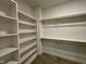 Walk-in closet with built in shelves and hanging rods at 3521 Amelia Grace Dr # 67, Fuquay Varina, NC 27526