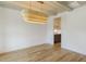 Bright dining room featuring a stylish chandelier, hardwood floors, and ample natural light from the windows at 3521 Amelia Grace Dr # 67, Fuquay Varina, NC 27526