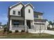 Attractive two-story home showcasing a stone-accented porch, a two-car garage, and a well-maintained yard at 3521 Amelia Grace Dr # 67, Fuquay Varina, NC 27526