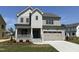 Charming two-story home boasts a two-car garage, inviting front porch, and manicured lawn at 3521 Amelia Grace Dr # 67, Fuquay Varina, NC 27526