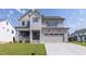 Stunning two-story home featuring a cozy front porch and an attached two-car garage at 3521 Amelia Grace Dr # 67, Fuquay Varina, NC 27526