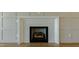 Bright living room with a white fireplace and stylish wood flooring at 3521 Amelia Grace Dr # 67, Fuquay Varina, NC 27526