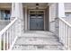 Welcoming front entrance with stone steps and charming doors at 3521 Amelia Grace Dr # 67, Fuquay Varina, NC 27526