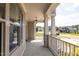 Spacious front porch with decorative pillars and serene neighborhood views at 3521 Amelia Grace Dr # 67, Fuquay Varina, NC 27526