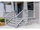 Inviting front porch featuring stone accents, white columns, and a welcoming entrance at 3521 Amelia Grace Dr # 67, Fuquay Varina, NC 27526