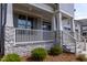 Charming covered front porch with stone accents and white railings, enhancing curb appeal at 3521 Amelia Grace Dr # 67, Fuquay Varina, NC 27526