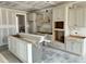 Unfinished kitchen featuring an island, unfinished cabinets, and undermount sink at 3521 Amelia Grace Dr # 67, Fuquay Varina, NC 27526
