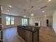 Open concept kitchen with a large island, stainless steel appliances, and seamless transition to living room at 3521 Amelia Grace Dr # 67, Fuquay Varina, NC 27526