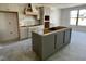 Unfinished kitchen featuring a central island and custom cabinets, awaiting countertops and appliances at 3521 Amelia Grace Dr # 67, Fuquay Varina, NC 27526