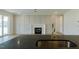 Modern kitchen features an island with stainless steel sink and views into the spacious living area at 3521 Amelia Grace Dr # 67, Fuquay Varina, NC 27526
