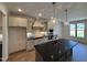 Modern kitchen featuring a spacious island, stainless steel appliances, and elegant pendant lighting at 3521 Amelia Grace Dr # 67, Fuquay Varina, NC 27526