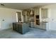 Unfinished kitchen featuring an island, unfinished cabinets, and undermount sink at 3521 Amelia Grace Dr # 67, Fuquay Varina, NC 27526