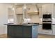 Modern kitchen with stainless steel appliances, an island, and custom cabinets at 3521 Amelia Grace Dr # 67, Fuquay Varina, NC 27526