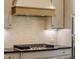 This custom kitchen boasts a gas cooktop, vent hood and stainless steel appliances at 3521 Amelia Grace Dr # 67, Fuquay Varina, NC 27526