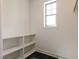 Laundry room with utility sink, storage shelf, and a large window at 3521 Amelia Grace Dr # 67, Fuquay Varina, NC 27526