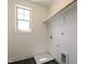 Laundry room with utility sink, storage shelf, and a large window at 3521 Amelia Grace Dr # 67, Fuquay Varina, NC 27526