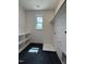 Laundry room with shelving, window, and black tile floor at 3521 Amelia Grace Dr # 67, Fuquay Varina, NC 27526