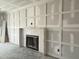 Unfinished living room with decorative molding and fireplace at 3521 Amelia Grace Dr # 67, Fuquay Varina, NC 27526