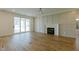 An open living area with hardwood floors, fireplace, and sliding glass doors to the patio at 3521 Amelia Grace Dr # 67, Fuquay Varina, NC 27526