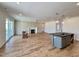 Spacious living room featuring hardwood floors, a fireplace, and a kitchen island at 3521 Amelia Grace Dr # 67, Fuquay Varina, NC 27526