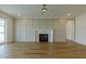 Spacious living room featuring hardwood floors, fireplace, and lots of natural light at 3521 Amelia Grace Dr # 67, Fuquay Varina, NC 27526