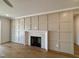 Bright living room featuring a fireplace, detailed wainscotting, and hardwood floors at 3521 Amelia Grace Dr # 67, Fuquay Varina, NC 27526