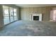 Unfinished living room featuring a fireplace, sliding glass doors, and an elegant design at 3521 Amelia Grace Dr # 67, Fuquay Varina, NC 27526