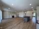 Spacious living room featuring a fireplace, an island with pendant lights, and hardwood floors at 3521 Amelia Grace Dr # 67, Fuquay Varina, NC 27526