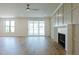 Bright and open living room with a sliding glass door and fireplace at 3521 Amelia Grace Dr # 67, Fuquay Varina, NC 27526