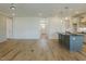 Open concept living space showcasing a kitchen island and open layout to the front entry at 3521 Amelia Grace Dr # 67, Fuquay Varina, NC 27526