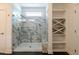 Glass shower featuring white marble tile, a built in shower seat, and built-in shelving at 3521 Amelia Grace Dr # 67, Fuquay Varina, NC 27526