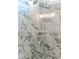 Close-up of a glass-enclosed shower featuring white marble tiling and chrome hardware at 3521 Amelia Grace Dr # 67, Fuquay Varina, NC 27526