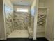 Unfinished shower featuring marble tile, built-in shelving, and a bench at 3521 Amelia Grace Dr # 67, Fuquay Varina, NC 27526
