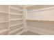 Spacious walk-in closet offers ample storage with built-in shelving and hanging rods at 3521 Amelia Grace Dr # 67, Fuquay Varina, NC 27526